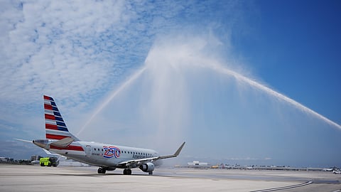 American Airlines Flight AA3599, the first direct commercial flight between the United States and Venezuela in seven years, gets a water cannon salute as it taxis away from the gate, Thursday, April 30, 2026, at Miami International Airport in Miami.