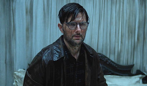 This image released by Neon shows Adam Scott in a scene from "Hokum."