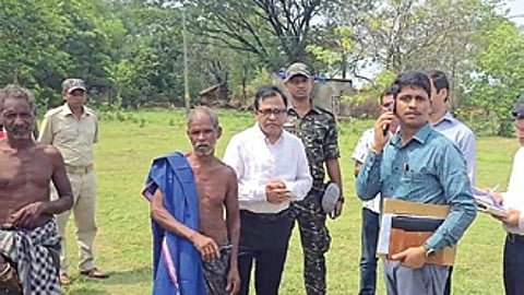 RDC Sangram Keshari Mohapatra(centre) along with officials during his visit to Jitu Munda (with towel on shoulder) at Dianali village in Keonjhar district