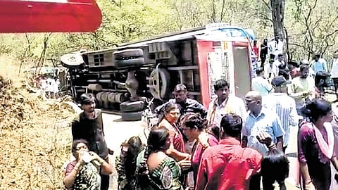 A view of the bus toppled near Ponnachi cross at MM hills in Mysuru on Friday.