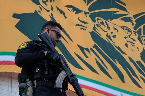 A police officer stands guard in front of a banner with portraits of the late Iranian revolutionary founder Ayatollah Khomeini, left, and late Supreme Leader Ayatollah Ali Khamenei in a state-organised rally celebrating the birthday of Imam Reza, the 8th Shiite Muslims' Imam, and supporting the supreme leader, in Tehran, Iran, Wednesday, April 29, 2026.