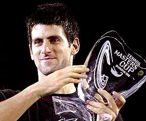 Novak Djokovic of Serbia holds the 2008 Tennis Masters Cup in Shanghai, China. (Photo: AP)