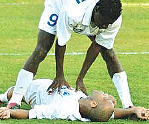 Striker Ranty Martins attends to Cristiano Junior after he collapsed in the 2004 Fed Cup final.