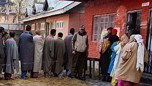 People wait to cast their vote in a queue outside a polling station in J&K. 