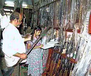 Cochin Armoury proprietor Sajan K Poulose recording the details of the guns deposited at his armoury by licensees/P K Jeevan Jose.