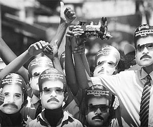 Schoolchildren wearing PRP president Chiranjeevi’s masks in Vijaywada on Sunday.