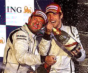Brawn GP F1 driver Jenson Button, right, celebrates with teammate Rubens Barichello of Brazil after winning the Australian Grand Prix. (Photo: AP)