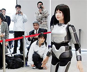 A "cybernetic human" HRP-4C, designed to look like an average Japanese woman, walks in front of journalists during a demonstration in Tokyo. AP