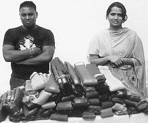 Lawrence Gajendran and Hakender Rupa in front of their stash of sarees in Hyderabad.