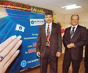Reserve Bank of India’s Ombudsman M Sebastian and State Bank of India Chief General Manager Shiva Kumar launching `Unhappy SMS Service’ in Hyderabad o