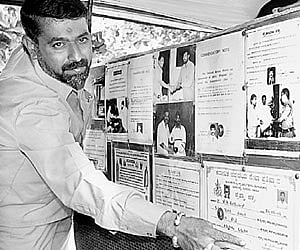 Auto driver Shivakumar showing the posters inside his auto.