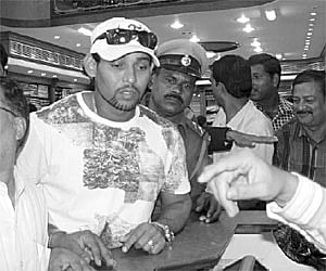 Sri Lankan all-rounder Tillakaratne Dilshan shops for sarees at a showroom near Sriya Square in Bhubaneswar on Sunday.