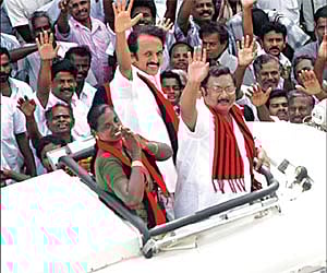 Local Administration Minister M K Stalin, his brother M K Azhagiri and DMK candidate Latha Adhiyaman, waving to the crowd from an open vehicle in Thir