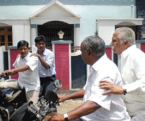 Congress candidate for Chikkodi constituency Prakash Hukkeri, rides pillion on a motorcycle during campaigning.