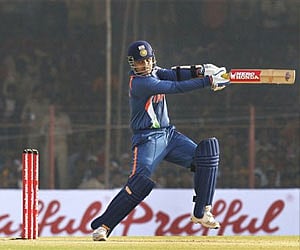 Virender Sehwag hits a four during the first one-day international cricket match between India and Sri Lanka, in Rajkot on Tuesday. (AP)