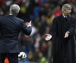 Arsenal's manager Wenger, alongside Manchester City's manager Hughes during their Carling Cup match at The City of Manchester Stadium. (AP)