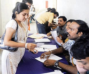 Young women queue up to fill application forms at the event.