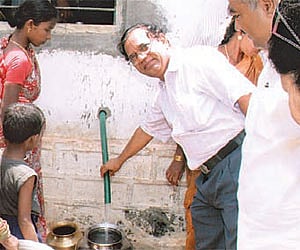 Dr J S Yadav, Director IICT checking water after the inauguration of the unit at Allapur, in Nalgonda district.