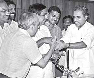 Sports Minister M Vijayakumar presenting the cash prize of Rs 25 lakh to the officials of the Viva Kerala Football Club at a function in Kochi on Thur