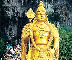 The statue of Lord Muruga in front of the Batu Caves in Malaysia.