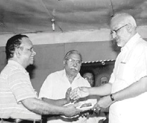 US-based engineer Girija Vallabhan handing over the donation amount for the Neyyattinkara Vasudevan Foundation to  Minister for Education and Culture