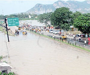 National highway No 9 submerged in flood waters at Mulapadu in Krishna district on Monday/Ch Narayana Rao .