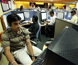 Employees at a call centre provide service support to international customers in Bangalore in this March 2004 (File photo/Reuters)