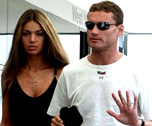 McLaren driver David Coulthard talks his Brazilian girlfriend Simone Abdelnour prior to the qualiflying session at the Hungaroring. (AP file photo)