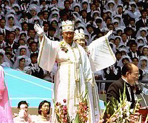 A 1992 file photo of Unification Church founder Rev. Sun Myung Moon and his wife at a wedding cermony in Seoul. (AP)