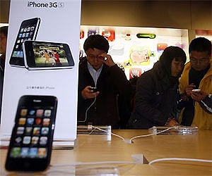 Customers take a close look at the Apple iPhone which is officially launched in mainland China at the apple store in Beijing, December 2023. 