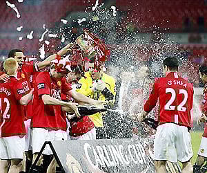 John O'Shea of ManU sprays champagne over his team after their penalty win over Tottenham Hotspur in the English League Cup finals in Wembley. AP