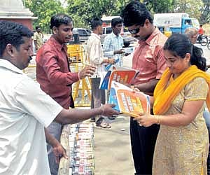 BIG DRAW: Parents buying books on engineering counselling outside the Anna University, in the city on Monday.