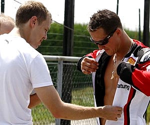 Michael Schumacher with Sebastian Vettel. (File photo / AP)