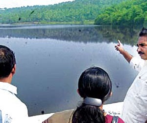Water Resources Minister N K Premachandran at the Poomala dam site in Thrissur on Monday.