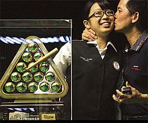 Ng On Yee is kissed by her father Ng Yam Shui after winning the title in Hyderabad on Tuesday/A Suresh Kumar.