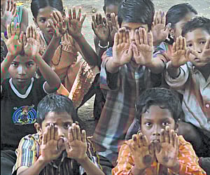 The children at Thondamuthur near Coimbatore show their palms stained from peeling arecanut.