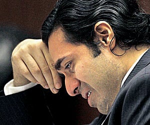 Anand Jon weeps in court while talking about the effect of his trial on his family.
