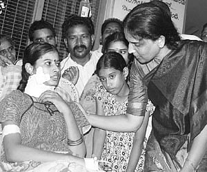 Home Minister Sabita Indra Reddy enquiring Anusha about her health condition at Government hospital in Rajahmundry on Saturday.
