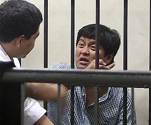 Mayor Andal Ampatuan Jr. of Unsay township, Maguindanao in southern Philippines, talks to his lawyer inside the NBI detention in Manila. AP