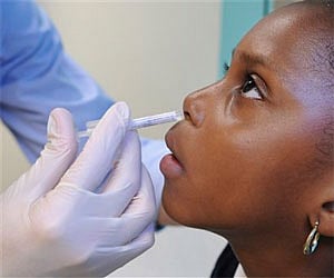 Asia Johnson, 6, of Boston, receives an intranasal H1N1 vaccine at the primary care clinic at Children's Hospital Boston, USA. (AP)