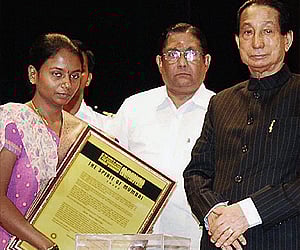 Maharashtra Governor S C Jamir felicitates daughter of matryr Assistant Sub-Inspector Tukaram Omble. (File photo: PTI)