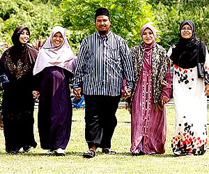 Mohammad Inaamulillah Bin Ashaari, centre, is seen with his four wives, near Kuala Lumpur. (Photo: AP)