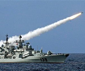 A warship launches a missile during a live-ammunition military drill held by PLA Navy in the South China Sea. (AP)