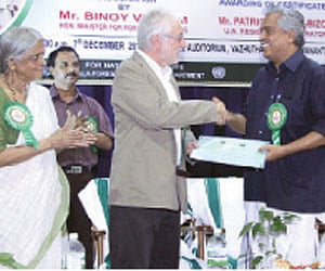 United Nations Resident Coordinator and UNDP resident representative Patrice  Coeur-Bizot handing over the certificates to the Forest Minister Binoy V