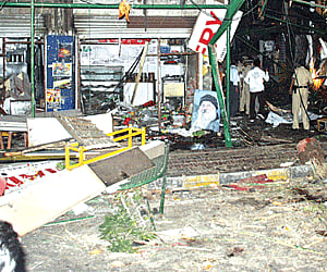Police and rescue workers inspect the blast site at German Bakery close to a Jewish prayer house and the Osho Ashram in Pune on Saturday.