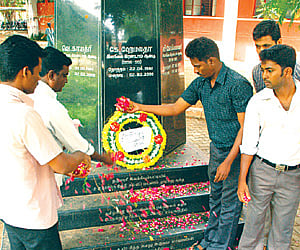 TNAU staff at a memorial set up in memory of the victims.