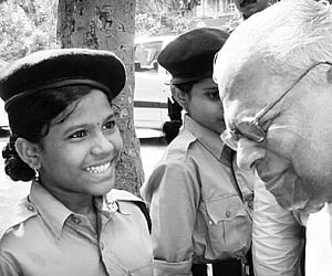 Young at heart: Chief Minister V S Achuthanandan interacting with an SPC at the state-level inauguration of Student Police Cadet project in Kozhikode.