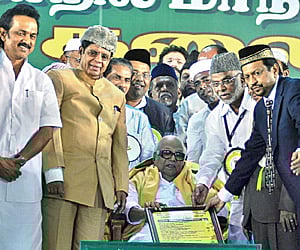 Chief Minister M Karunanidhi receiving the Communal Harmony Award as Union Minister E Ahamed and Deputy CM M K Stalin look on