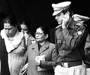 Police escorting Neera Yadav (centre), former Chief Secretary of Uttar Pradesh, to jail from a court in Ghaziabad on Tuesday