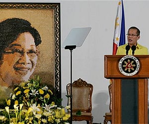Philippine President Benigno Aquino III delivers a speech beside a portrait of his mother Corazon Aquino in Manila on Sunday. (AP)